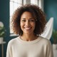Portrait of a smiling woman in her 30s, with a soft-focus background.